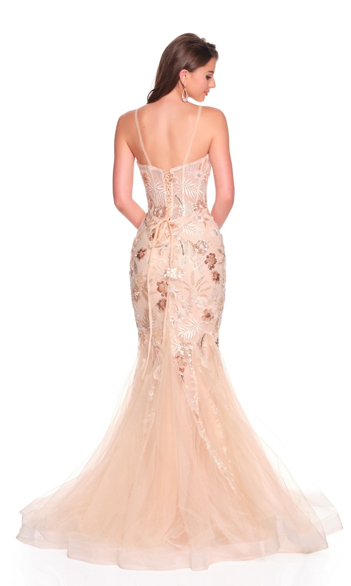 A woman models the Dave and Johnny 12469 long prom dress, a fitted, blush mermaid gown with lace details, corset bodice, and thin straps, shown from the back against a white background.